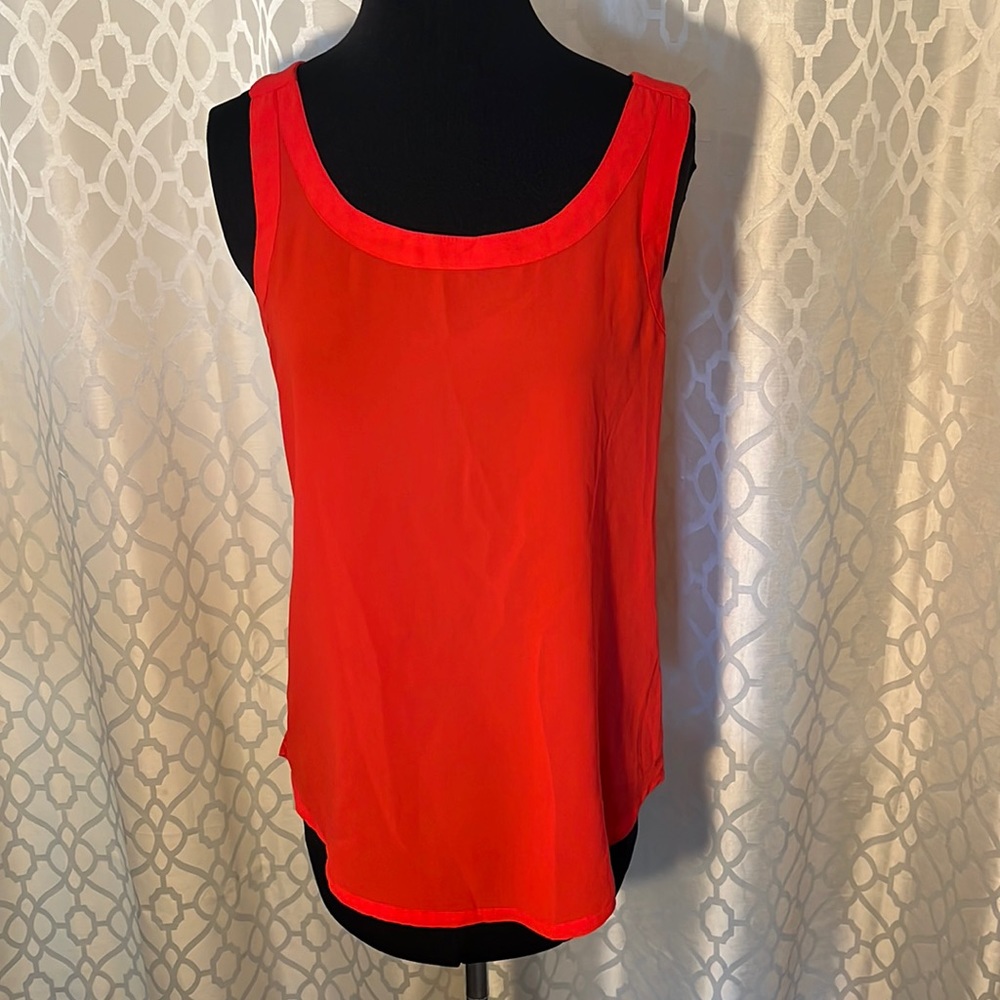 Red women’s sleeveless top with gold zipper on back. Size M